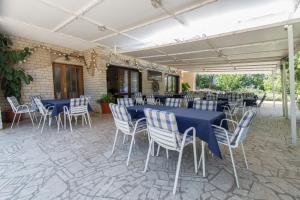 a set of tables and chairs with blue table cloth at Stella Maris Accommodation in Klenovica