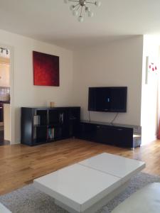 a living room with a white table and a flat screen tv at Beautiful Kingston apartment in Kingston upon Thames