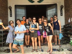 a group of people standing in front of a house at Vangvieng Rock Backpacker Hostel in Vang Vieng