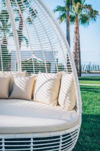 a large white bed sitting in the middle of a grassy field at Iberostar Selection Marbella Coral Beach in Marbella