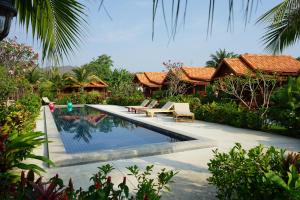 a swimming pool in front of a villa at Thai House Resort in Hua Hin