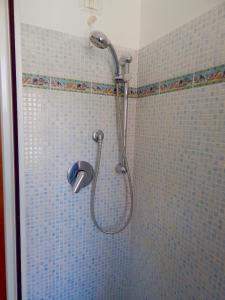 a shower with a shower head in a bathroom at N148 - Numana, nuovo trilocale con terrazzo a 350 metri dal mare in Numana