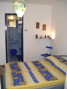 a bedroom with a bed and a bathroom at Apartments Adria Blue in Jelsa