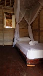 Ein Bett oder Betten in einem Zimmer der Unterkunft Beranda Ecolodge