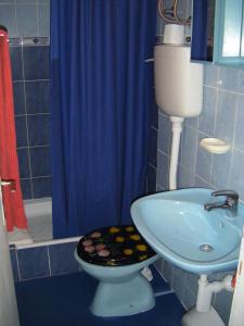 a blue bathroom with a toilet and a sink at Apartments Adria Blue in Jelsa +20 photos