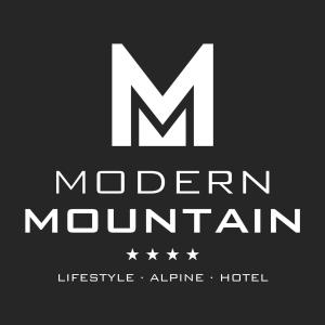 a black and white photo of a sign at Hotel Modern Mountain in Ischgl