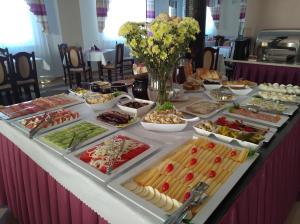 a buffet of food on a long table at Czerwone Wierchy - sauna i jacuzzi wliczone w cenę podczas pobytu! in Białka Tatrzanska