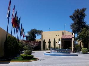 a building with several flags in front of it at Casa Cantarranas in Tehuacán