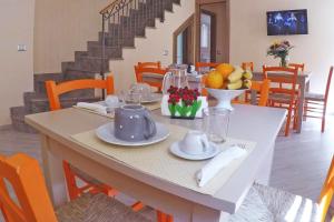 a dining room with a table with fruit on it at BB Aretè in Scilla +23 photos