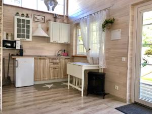 a kitchen with a table and a stove at Naujos statybos namelis in Palanga +29 photos