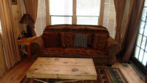 a living room with a couch and a coffee table at Cedar Pines Resort in South Lake Tahoe