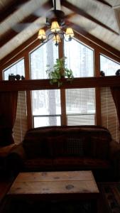 a living room with a couch in front of a window at Cedar Pines Resort in South Lake Tahoe