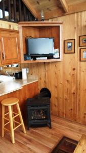 a living room with a stove and a tv at Cedar Pines Resort in South Lake Tahoe