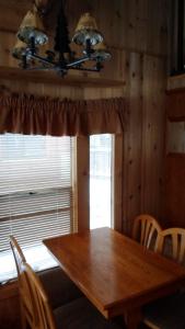 a dining room with a wooden table and a window at Cedar Pines Resort in South Lake Tahoe