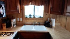 a kitchen with a sink and a stove and a window at Cedar Pines Resort in South Lake Tahoe +37 photos