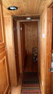 a hallway with wood paneling and a door with a rug at Cedar Pines Resort in South Lake Tahoe