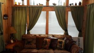 a living room with a couch in front of a window at Cedar Pines Resort in South Lake Tahoe