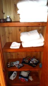 a shelf in a room with a bed and towels at Cedar Pines Resort in South Lake Tahoe