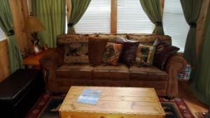 a living room with a couch and a coffee table at Cedar Pines Resort in South Lake Tahoe