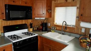 a kitchen with a stove and a sink at Cedar Pines Resort in South Lake Tahoe