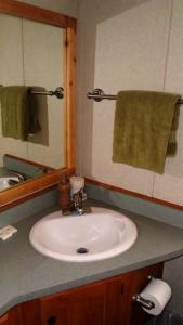a bathroom with a sink and a mirror at Cedar Pines Resort in South Lake Tahoe