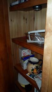 a small cabinet with wooden shelves with food items on it at Cedar Pines Resort in South Lake Tahoe