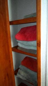 a closet with a stack of folded towels at Cedar Pines Resort in South Lake Tahoe