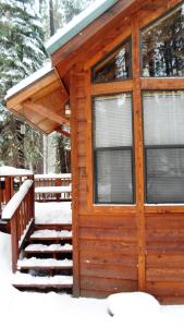 a cabin in the snow with a porch at Cedar Pines Resort in South Lake Tahoe