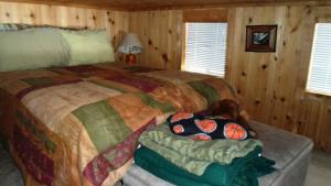 a bedroom with a large bed in a cabin at Cedar Pines Resort in South Lake Tahoe