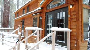 a cabin in the woods in the snow at Cedar Pines Resort in South Lake Tahoe