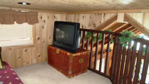 a tv sitting on top of a chest in a room at Cedar Pines Resort in South Lake Tahoe