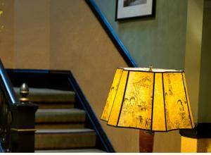 a yellow lamp sitting next to a set of stairs at Hotel Boheme in San Francisco