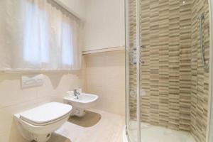 a bathroom with a shower and a toilet and a sink at La Casa nel Borgo sul Lago in Pisogne +26 photos