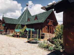 a large log cabin with a green roof at Ra in Bukovel