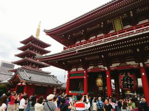 a crowd of people standing in front of a building at ぷふか浅草 in Tokyo