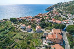 an aerial view of a village next to the ocean at Appartamento Costa del Sole in Pomonte