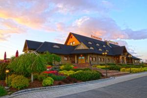 a lodge with a garden in front of a building at Hotel Rycerski in Czeladź