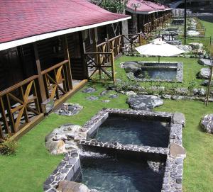 two pools of water in front of a building at Ming Lu Holiday Hotel in Renai