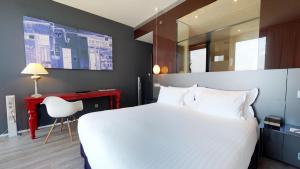 a hotel room with a large bed and a television at Melia Barcelona Sky 4* Sup in Barcelona