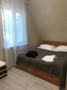 1 dormitorio con 2 camas y ventana en Dubrava Park-Hotel, en Samara