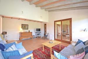 a living room with a blue couch and a table at Villa Font in Artá