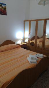 a bedroom with a large bed with towels on it at Appartamenti S'Agapo' in Catanzaro Lido