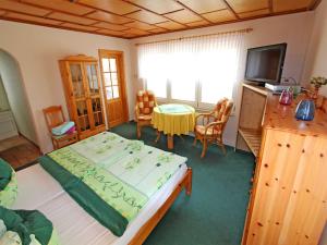 ヴァーレンにあるFerienhaus Waren Mueritz SEE 9621のベッドルーム(ベッド1台、テーブル、テレビ付)