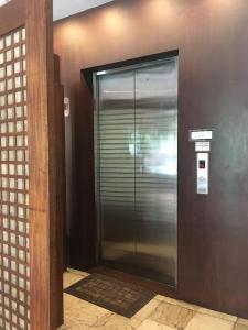 a elevator in a building with a metal door at Hotel Maiya in San Jose
