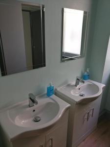 a bathroom with two sinks and a mirror at Birmingham Central Backpackers in Birmingham +9 photos