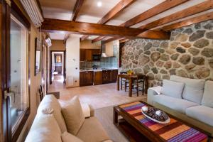 a living room with a couch and a table at Alfabia Nou Agroturismo in Bunyola