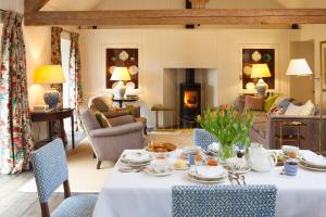 a living room with a table and a fireplace at Gutchpool Farm in Gillingham