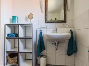 a bathroom with a sink and a mirror at Ferienwohnung im Weiler in Winterlingen