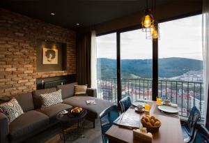 a living room with a couch and a large window at Cityloft 161 in Istanbul
