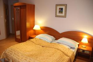 a bedroom with a bed with two pillows on it at Villa Aqua in Międzyzdroje +21 photos